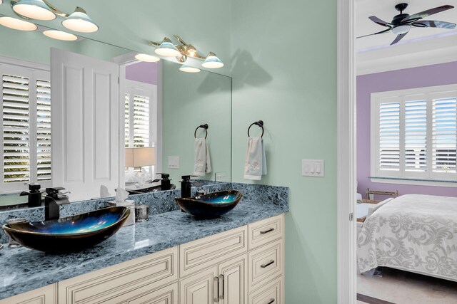 bathroom with ceiling fan, a healthy amount of sunlight, and vanity