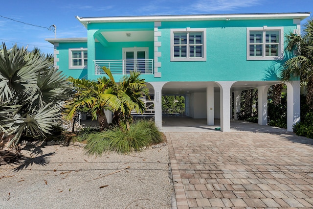 view of front of property with a carport and a balcony