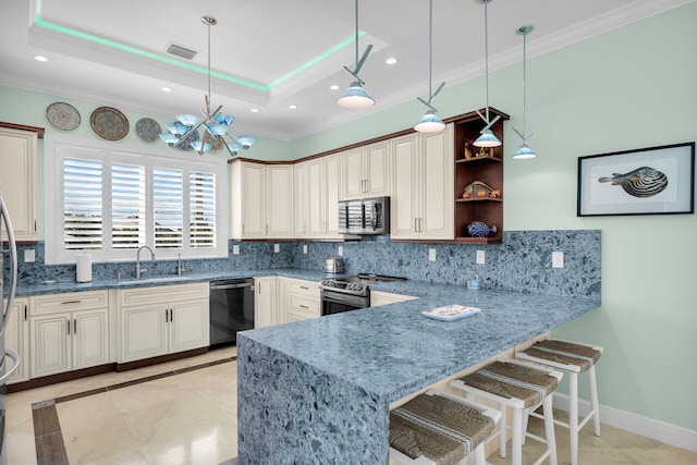 kitchen with decorative light fixtures, stainless steel appliances, a raised ceiling, and kitchen peninsula