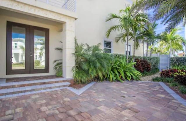 entrance to property featuring french doors and a patio