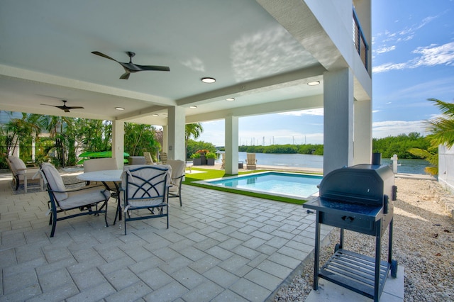 949 24th St, Ocean, Marathon, FL 33050 - view of patio with outdoor dining area, a ceiling fan, an outdoor pool, a water view, and a grill