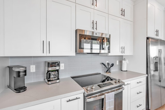 949 24th St, Ocean, Marathon, FL 33050 - kitchen featuring stainless steel appliances, tasteful backsplash, white cabinetry, and light stone countertops