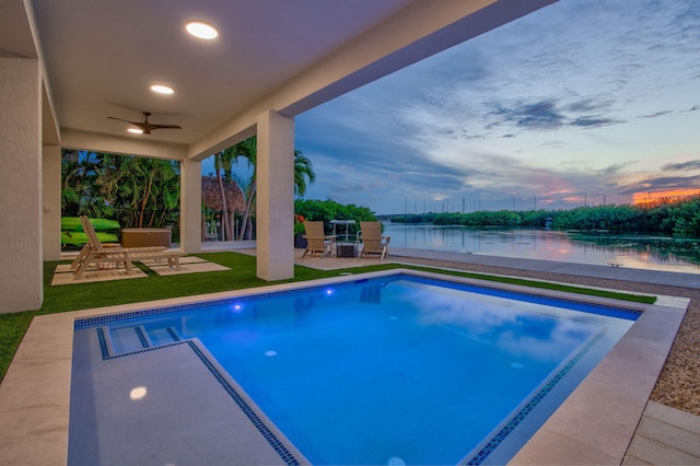 949 24th St, Ocean, Marathon, FL 33050 - pool at dusk with a ceiling fan, a water view, a patio area, and an outdoor pool