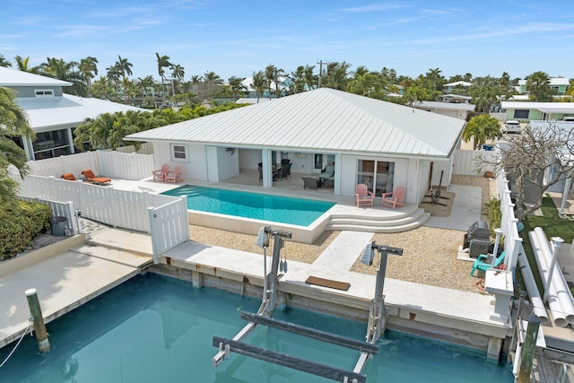 150 10th St, Key Colony, FL 33051 - rear view of house with boat lift, a patio area, and a fenced backyard