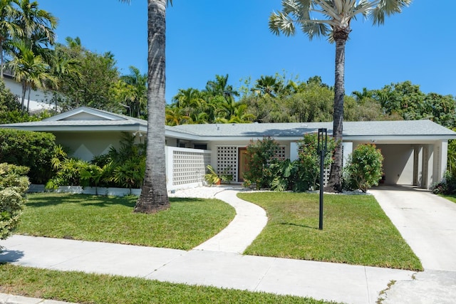 1110 Johnson St, Key West, FL 33040 - view of front of home with a front lawn, stucco siding, concrete driveway, and an attached carport