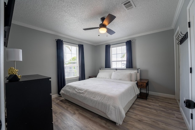 45 1st St, Big Coppitt, FL 33040 - bedroom with ceiling fan, a textured ceiling, visible vents, wood finished floors, and baseboards