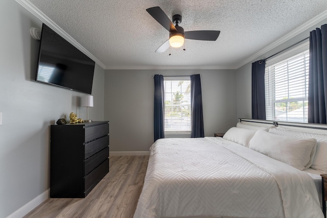 45 1st St, Big Coppitt, FL 33040 - bedroom featuring light wood-type flooring, a textured ceiling, ceiling fan, and baseboards