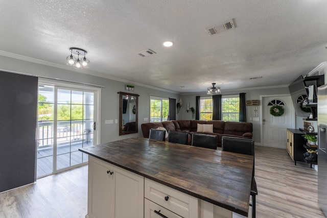 45 1st St, Big Coppitt, FL 33040 - kitchen with butcher block countertops, a textured ceiling, a chandelier, and visible vents