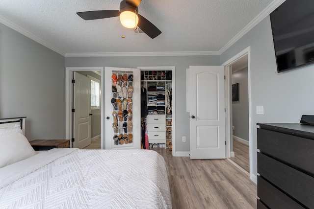 45 1st St, Big Coppitt, FL 33040 - bedroom featuring crown molding, a closet, a textured ceiling, and light wood-style floors