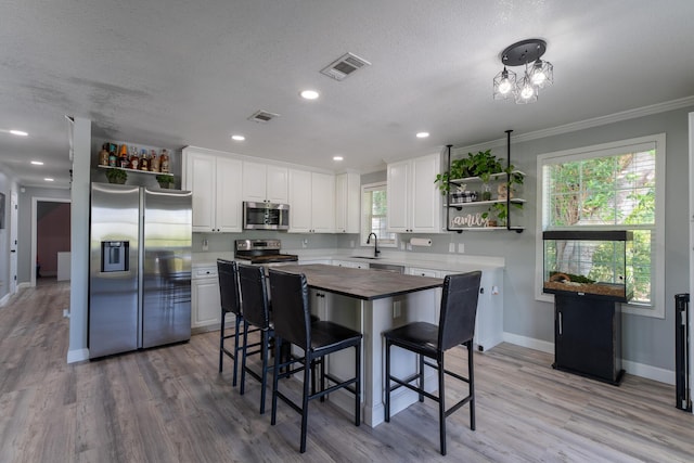 45 1st St, Big Coppitt, FL 33040 - kitchen with visible vents, open shelves, butcher block counters, and stainless steel appliances
