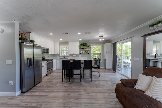 45 1st St, Big Coppitt, FL 33040 - kitchen with crown molding, a sink, stainless steel appliances, open floor plan, and visible vents