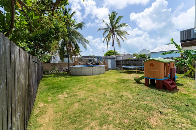 45 1st St, Big Coppitt, FL 33040 - view of yard featuring a trampoline, a fenced in pool, an outdoor structure, a fenced backyard, and a storage unit