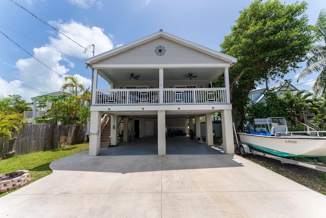45 1st St, Big Coppitt, FL 33040 - coastal home with ceiling fan, fence, stairs, driveway, and a carport