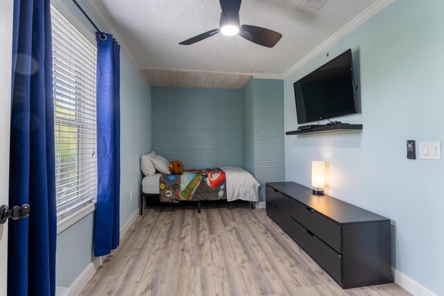 45 1st St, Big Coppitt, FL 33040 - bedroom featuring ceiling fan, a textured ceiling, crown molding, baseboards, and light wood-style flooring