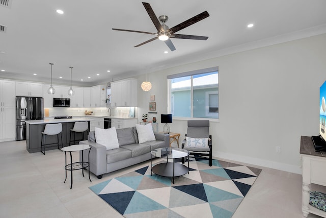 living room with crown molding, ceiling fan, and sink