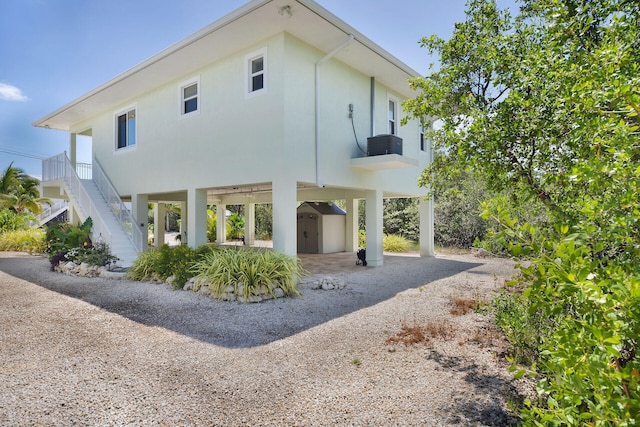 view of home's exterior featuring a carport and a shed