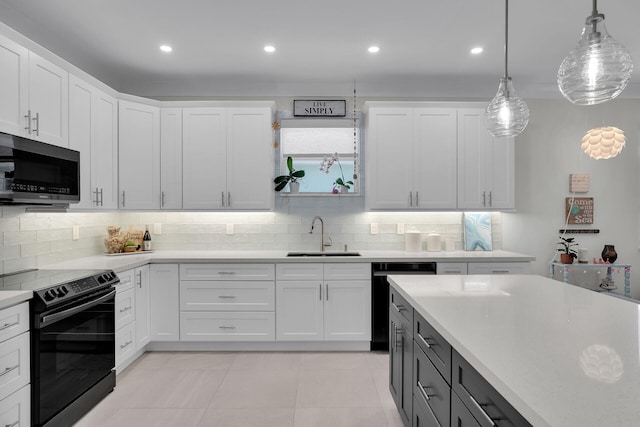 kitchen featuring decorative light fixtures, tasteful backsplash, sink, white cabinets, and black appliances