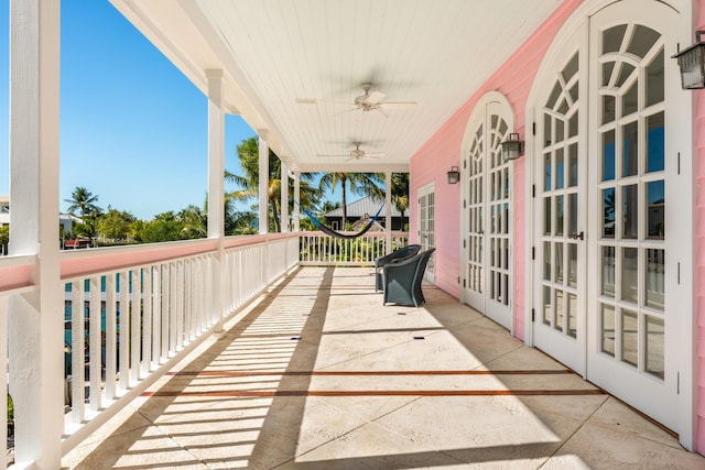 balcony featuring ceiling fan and french doors