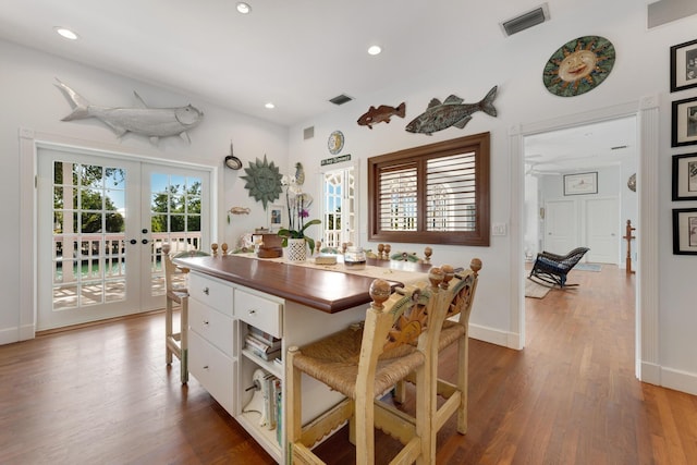 dining area featuring french doors, wood finished floors, visible vents, and recessed lighting