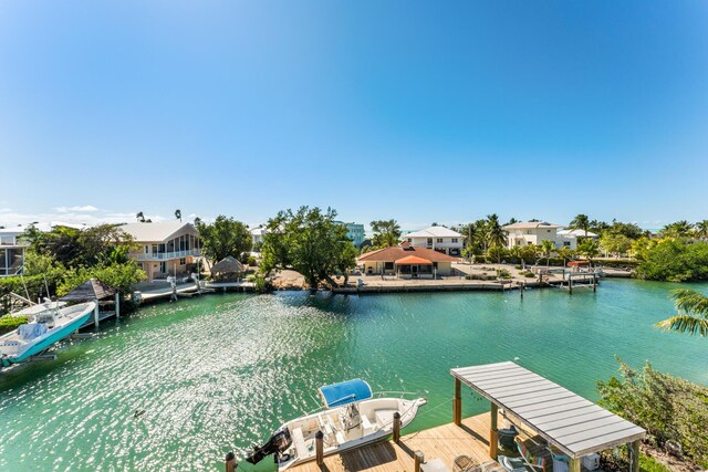 view of dock featuring a water view and a residential view