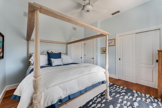 bedroom featuring wood finished floors, visible vents, and baseboards