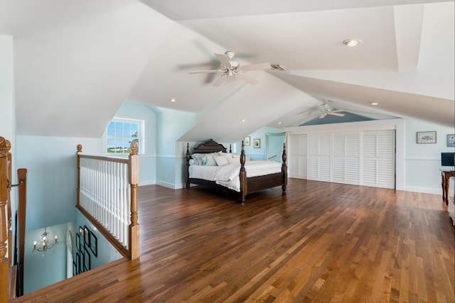 bedroom with lofted ceiling, wood finished floors, visible vents, and baseboards