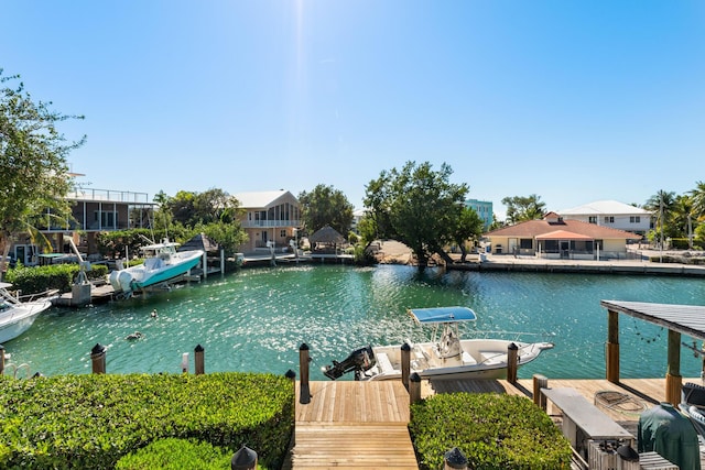 dock area featuring a residential view, a water view, and boat lift