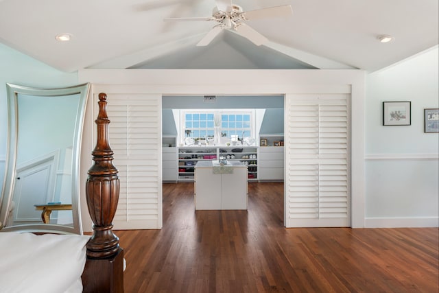 interior space featuring recessed lighting, a ceiling fan, baseboards, vaulted ceiling, and dark wood finished floors