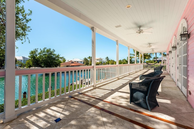 view of patio / terrace with a water view and ceiling fan