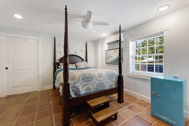 bedroom with recessed lighting, tile patterned flooring, a wall unit AC, and baseboards