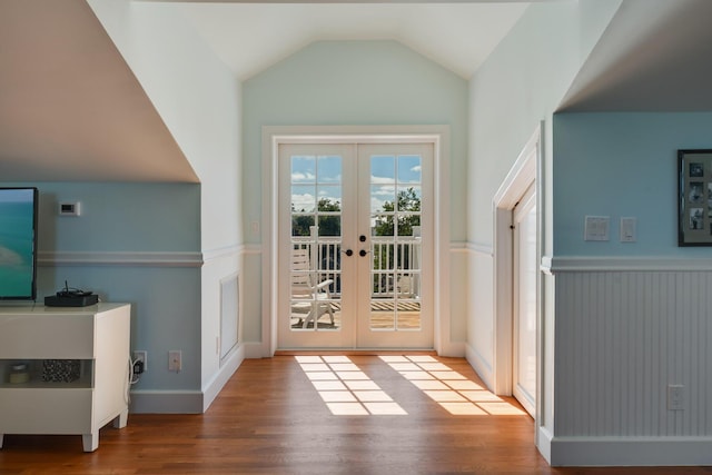 doorway to outside with visible vents, vaulted ceiling, wood finished floors, and french doors