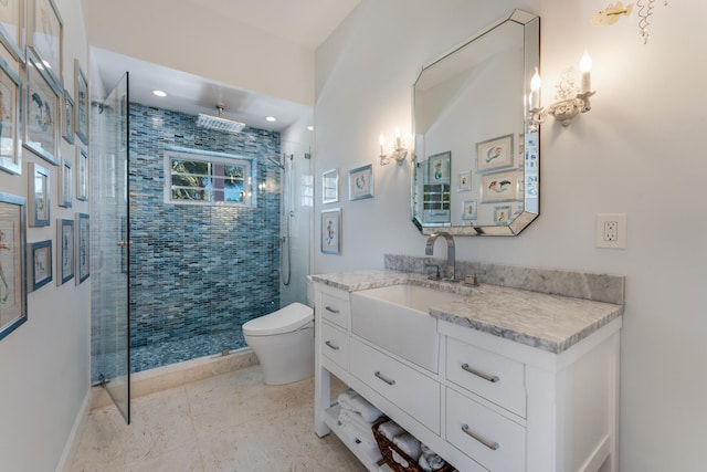 full bath featuring a stall shower, baseboards, vanity, and toilet