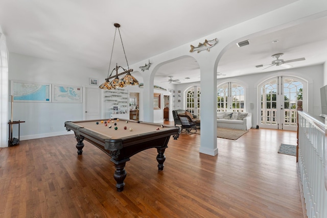 recreation room featuring visible vents, arched walkways, ceiling fan, wood finished floors, and french doors