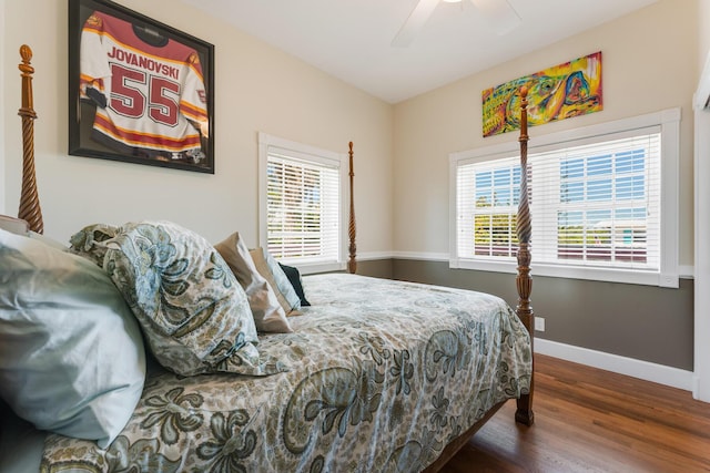 bedroom featuring a ceiling fan, baseboards, and wood finished floors