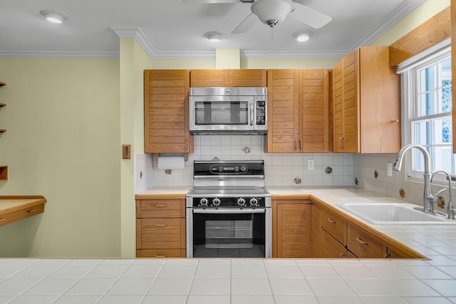 1514 Shaw Dr, Key Largo, FL 33037 - kitchen featuring stainless steel appliances, tile counters, backsplash, ornamental molding, and ceiling fan