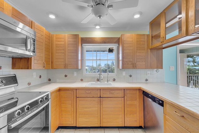 1514 Shaw Dr, Key Largo, FL 33037 - kitchen featuring appliances with stainless steel finishes, decorative backsplash, glass insert cabinets, ceiling fan, and ornamental molding