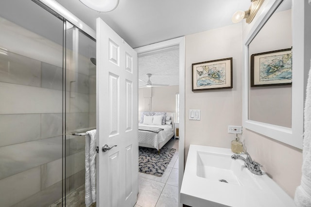 bathroom with a stall shower, tile patterned flooring, vanity, and ensuite bathroom