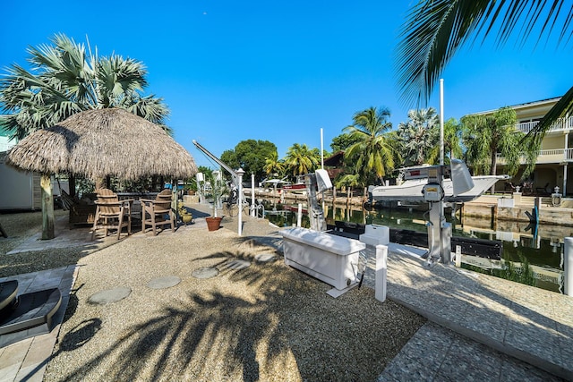 dock area with a water view and boat lift