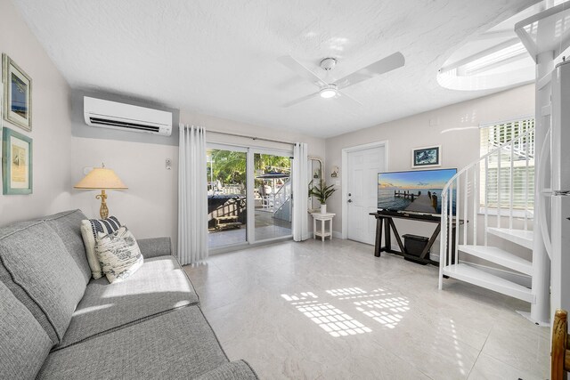 bedroom with a ceiling fan, a wall unit AC, and a textured ceiling