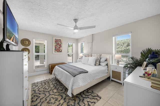 bedroom with multiple windows, a ceiling fan, and light tile patterned flooring