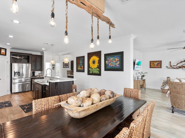 dining room featuring ceiling fan, light wood finished floors, crown molding, and recessed lighting