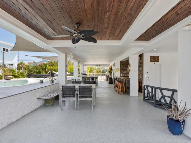 view of patio with a bar and a ceiling fan
