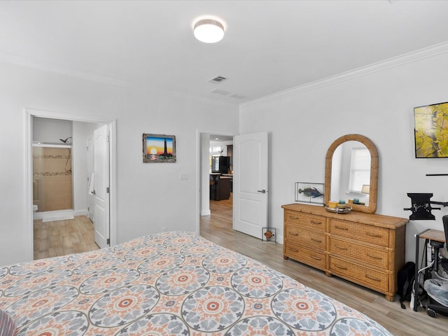 bedroom with ornamental molding and light wood-style flooring