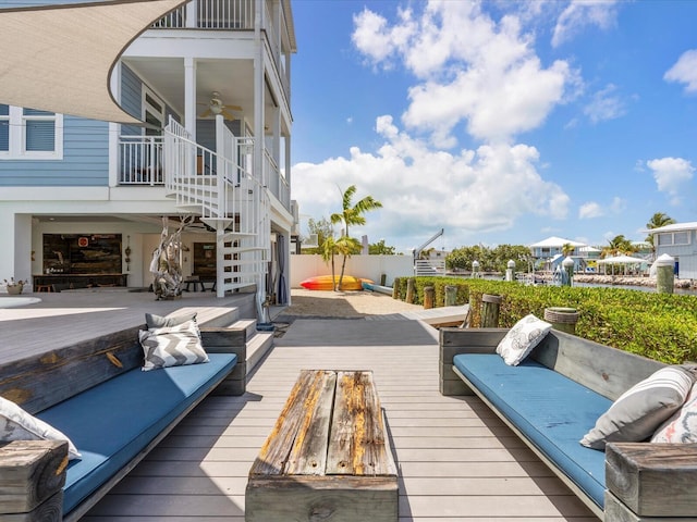 wooden deck with stairs, an outdoor hangout area, ceiling fan, and fence