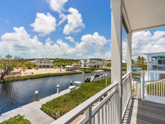 balcony featuring a water view and a boat dock