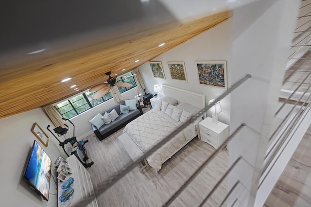 bedroom featuring wood ceiling, wood-type flooring, and vaulted ceiling