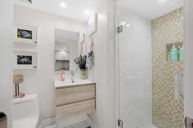 bathroom with vanity, toilet, and walk in shower