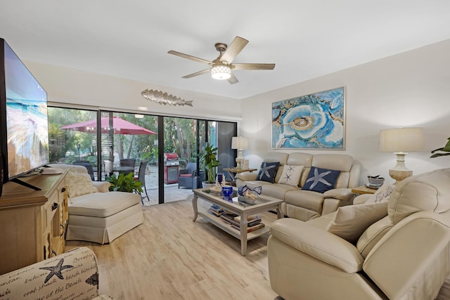 living room featuring ceiling fan and light hardwood / wood-style flooring