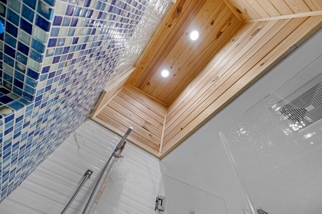 interior details with wood ceiling and walk in shower