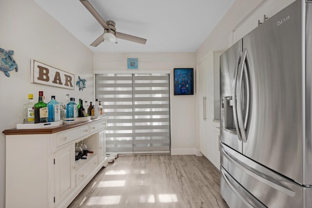 kitchen featuring stainless steel refrigerator with ice dispenser, white cabinetry, ceiling fan, and light hardwood / wood-style floors